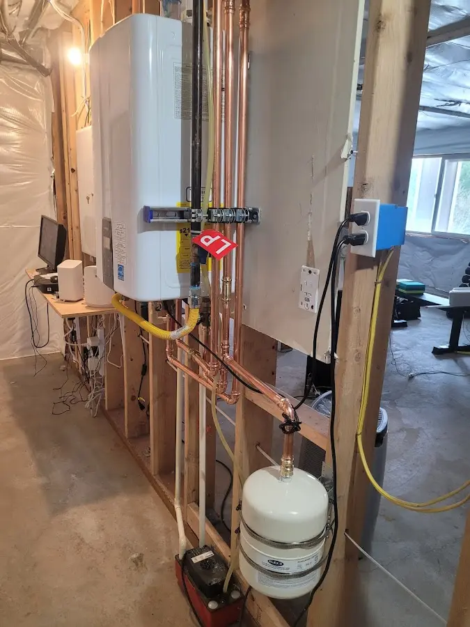 Licensed plumber repairing a kitchen sink in Volney
